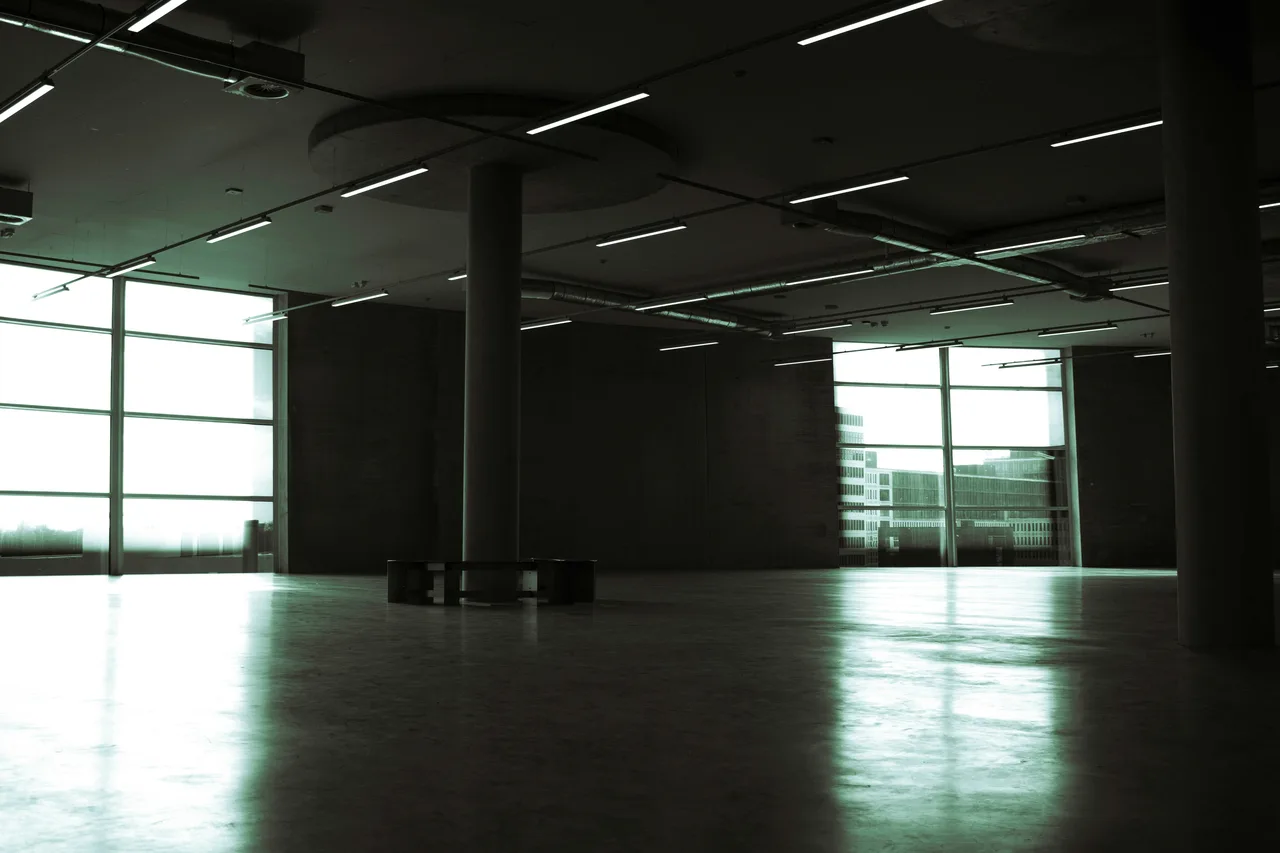 Touring an empty event venue interior before booking