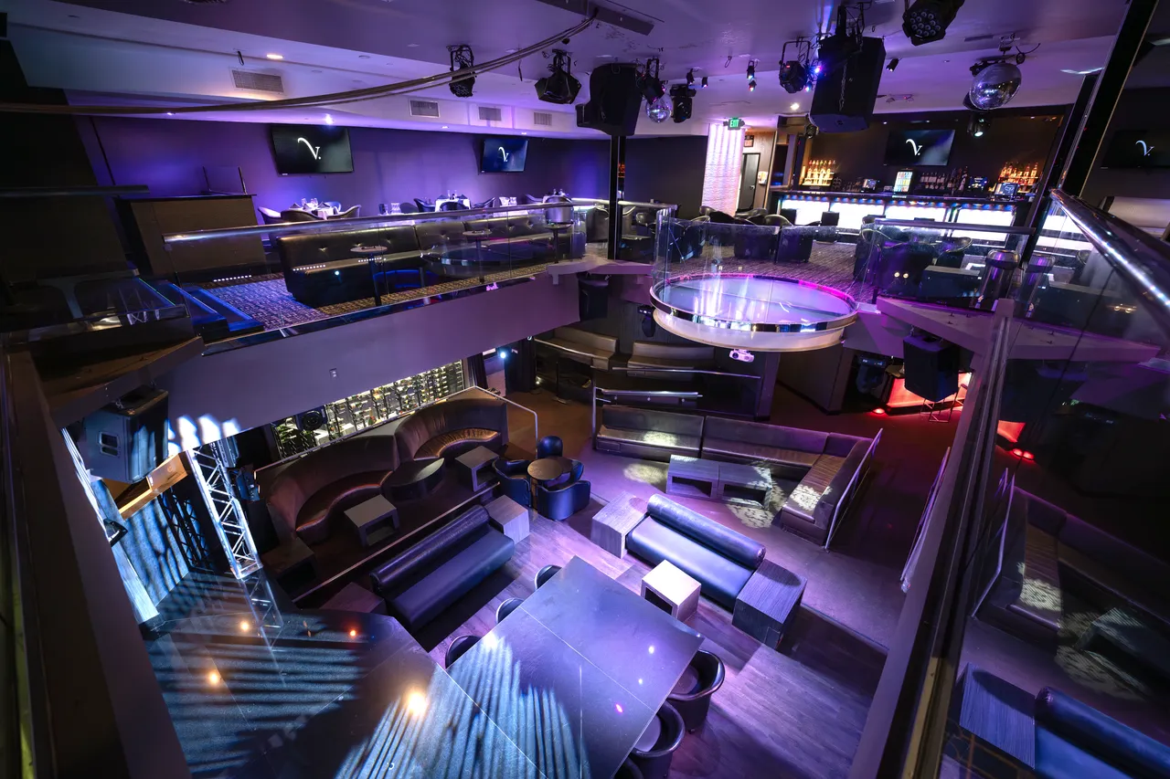 Venue 412 in San Francisco — elevated view of the two-level main room showing the bottle service banquettes, dance floor, and the mezzanine dining tables above.