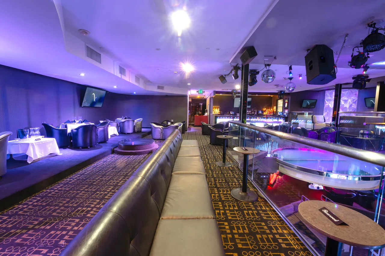 Venue 412 mezzanine seating with banquettes, dining tables, and a clear sightline down to the main floor and bar below.